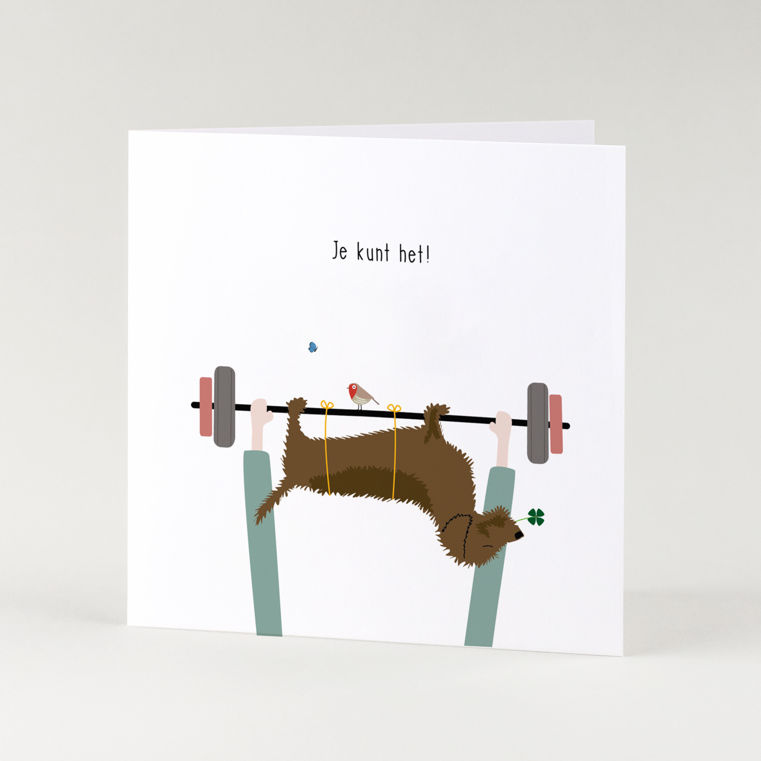 Succeskaart teckel - Frits hangt languit over een halter met klavertje vier